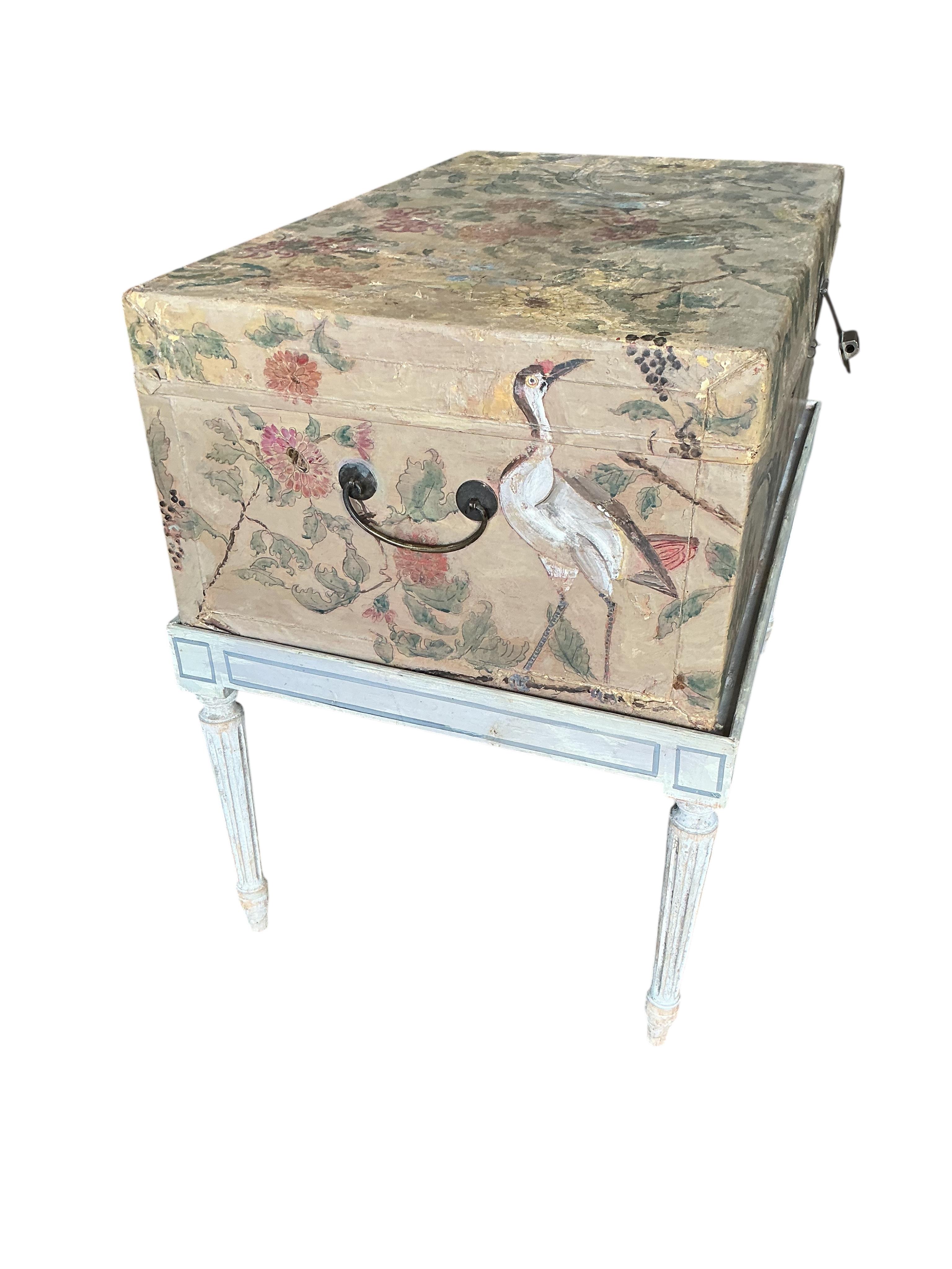A Chinese painted hide chest on a cream painted parcel gilt stand, width 77cm, depth 50cm, height 67cm